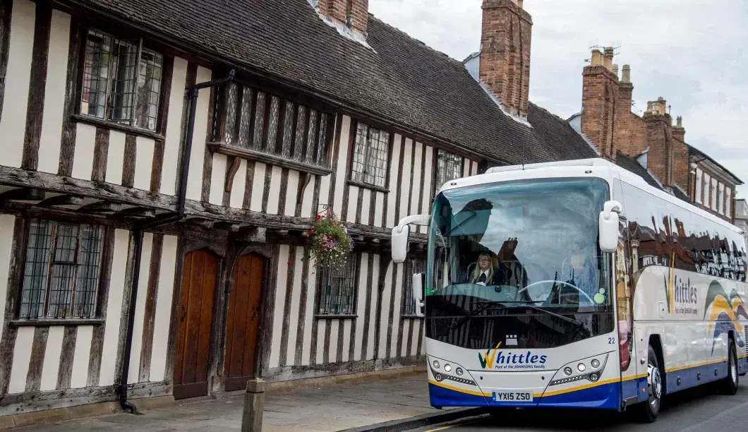 Whittles coach infront of Tudor house