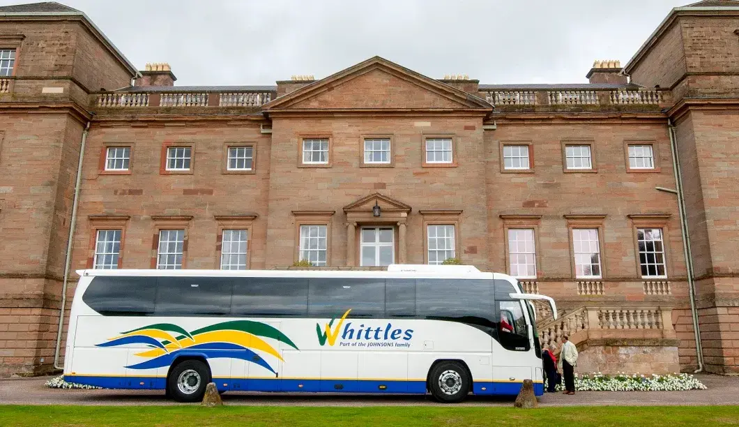 Whittles coach side view infront of building